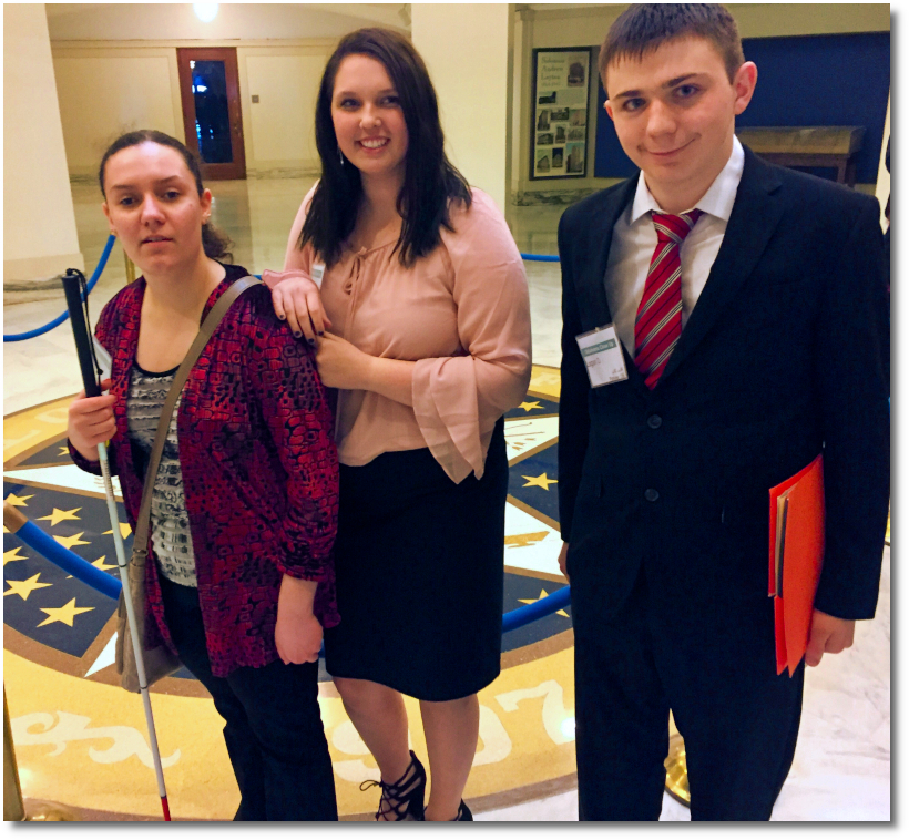 Three students smiling for camera at state capitol