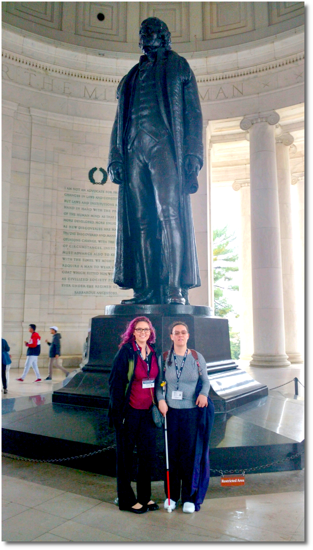 Two student in front of monument